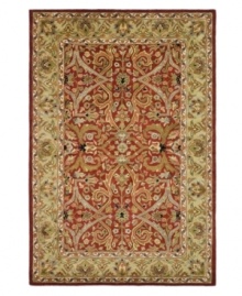 A luxurious arrangement of swirling florals gives this Safavieh area rug a decidedly classical appeal. Tufted in India from pure wool, this rug boasts a background of deep red and a supporting palette of color that creates a beautiful contrast of light and dark. (Clearance)