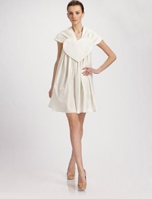 Channel quirky Parisian style with this crisp cotton blend frock, detailed with a heart on the front and a portrait collar that extends gracefully off the shoulders.Portrait collar Heart plaque at front Pleated body Side zipper with hook-and-eye Fully lined About 38 from shoulder to hem 95% cotton/5% other fibers Hand wash or dry clean Made in Italy