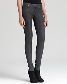 These Helmut Lang skinny jeans boast a coated glossy wash for subtle sheen, streamlining themselves with these season's glamour trend.