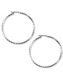 Jones New York's stylish twist on the classic hoop earring features detailed diamond-cut designs. Crafted in silver tone mixed metal. Approximate diameter: 2 inches.