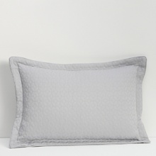 Fashioned from a luxe, cotton metelassé, this pillow is embellished with a textured geometric pattern allover. Elegant with trim, it complements the Vintage Tiles collection.