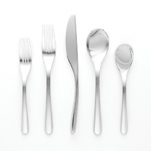 Aura five-piece place setting by Nambé. Made of forged 18/10 stainless steel and polished to a mirror finish, these pieces are exceptionally lustrous, durable and rust resistant. Setting consists of dinner fork, salad fork, knife, teaspoon, and tablespoon.