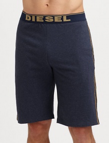 A casual elongated version with logo waistband and contrast piping. Elastic logo waistbandHits above kneeInseam, about 8CottonMachine washImported