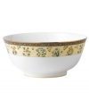 The exotic India dinnerware presents a pattern of exquisitely detailed florals on a yellow and deep blue band against pure white bone china. From Wedgwood's collection of salad bowls.