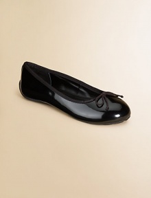 A timeless ballet flat becomes a seasonal staple in shiny patent leather with grosgrain trim and bow detail.Elastic strapPatent leather upperLeather liningRubber soleImported