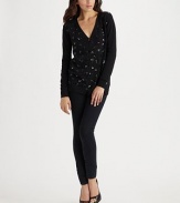 Freeform hearts delineated in shimmering sequins are sprinkled all across the front of a classic cardigan.V neckline Front buttons Long sleeves with ribbed cuffs Ribbed bottom Plain sleeves and back Abut 28 from shoulder to hem 31% nylon/29% viscose/27% cotton/13% wool Dry clean Imported