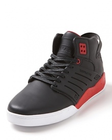 A lean, mid-top sneaker rendered in full-grain leather with bold color block accents and engineered side panels.