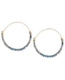 Tiny beads make a big statement on this pair of hoop earrings from Kenneth Cole New York. The silver and blue cherry beads adorn the earrings crafted from gold-tone mixed metal for a stunning look. Approximate drop: 2-1/4 inches.