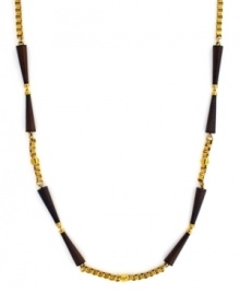 An earthy-cool blend. Vince Camuto combines wooden beads with an intricate box chain in gold tone mixed metal on this long, luxurious style. Approximate length: 36 inches.