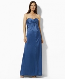 Exquisitely rendered from rippling stretch satin, this Lauren by Ralph Lauren dress is cut in a floor-skimming strapless silhouette with an elegant knot detail that embodies vintage glamour. (Clearance)