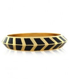 A pattern with panache. Vince Camuto's bangle bracelet is crafted from gold-tone mixed metal and black enamel with a bold chevron design for a stylish touch. Approximate diameter: 3-1/2 inches.