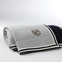 The University quilt in sumptuous channel-quilted cotton fleece combines soft waffle-knit cotton, striped edges and a quartered crest patch for a preppy, collegiate look.