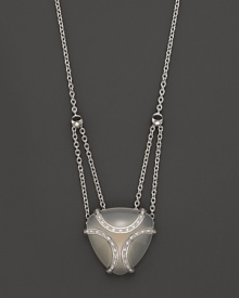 A bold sterling silver cage, glistening with diamonds, encases a gleaming white onyx stone. By Di MODOLO.