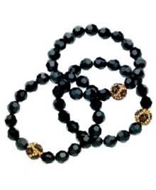 Bold and fierce. GUESS's three bracelet set features shiny black and leopard-printed beads in shining glass. Bracelets stretch to fit wrist. Approximate diameter: 2 inches.