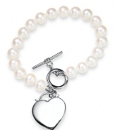 Cultured freshwater pearls (7-8 mm) get a modern update with a chic toggle clasp and polished heart charm in sterling silver. Approximate length: 7-1/2 inches. Approximate charm drop: 1 inch.