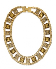 Golden wonders. With pyramid studs and crystal accents, this box-chain collar necklace is an edgy creation. Finished with a fold-over clasp with logo. Crafted in gold tone brass. Approximate length: 16 inches.