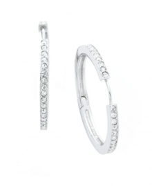 Timeless style with a hint of sparkle. Eliot Danori's traditional hoop earrings experience a dazzling touch with the addition of a seamless row of round-cut crystals. Set in silver tone mixed metal. Approximate diameter: 1-1/8 inches.