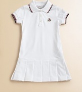 Soft, airy pique knit with sporty stripes, perfect for your future tennis star.Ribbed polo collar with two-color striped tippingShort sleeves with ribbed, tipped cuffsButton placketLogo appliqué at chestDropped waist with box pleated skirt96% cotton/4% elastaneMachine washImported Please note: Number of buttons may vary depending on size ordered. 