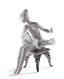 This young ballerina has graceful poise, even while primping for her moment on stage. With lustrous silver leaf accents and an intricate lace trimmed tutu, this hand-painted figurine is a beautiful gift for any aspiring dancer. 6 x 4.75.