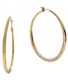 Don't be subtle, stand out! Michael Kors' shimmering hoop earrings feature a shiny gold tone mixed metal setting decorated at the bottom by sparkling crystals. Approximate diameter: 2 inches.