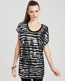 Exotic zebra stripes get glitzed on this MICHAEL Micahel Kors sequin top, designed in a tunic length for chic styling over leggings and skinny jeans.