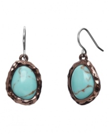 A natural blend. Monet's pretty drop earrings feature reconstituted turquoise stones that stand out against a bronze tone mixed metal setting. Earrings feature a silver tone ear wire backing. Approximate drop: 3/4 inch.