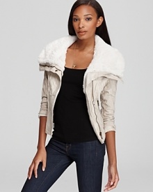 Right on trend for fall, the oh-so feminine, cropped silhouette of this uber-stylish GUESS jacket has arrived--fashioned with a lofty faux shearling collar and zipper details for warmth and modern edge.