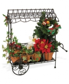 Brimming with the traditional red and green plants of Christmas, this handcrafted cart complements the Cries of London figurines, also from Byers' Choice.