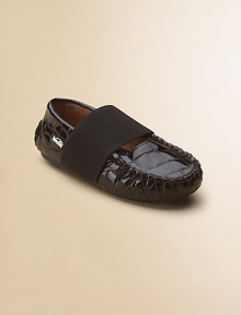 A classic moccasin design in embossed crocodile patent leather keeps the foot in place with a thick elastic strap.Slip-on with elastic closureLeather upperLeather liningRubber solePadded insoleImported