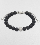 Rich black onyx, accented by a brilliant pavé diamond ball, is fastened by an adjustable clasp of textured sterling silver.Diamonds, 0.87 tcw Black onyx Sterling silver Bead diameter, about ¾ Imported