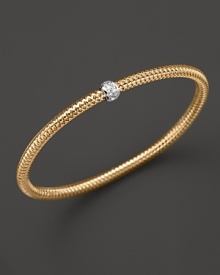 A single diamond station shines on this modern 18K gold mesh bangle from Roberto Coin.