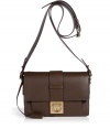 Invest in classic sophisticated style with Salvatore Ferragamos luxurious dark brown leather crossbody bag - Boxy shape, front flap with gold-tone Gancini logo lock closure, buckled crossbody strap, inside front sectional pocket, zippered back wall pocket, leather lining - Perfect for off-duty chic or elegant workweek style