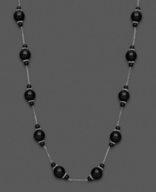 Mysterious loveliness. Show your dark side with this necklace with black onyx beads (4-10 mm). Set in sterling silver. Approximate length: 18 inches.