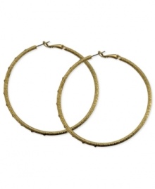 A stylish must-have. These clutchless hoop earrings from GUESS feature a diamond dust design with glass stones. Crafted in gold tone mixed metal. Approximate diameter: 2-1/2 inches.