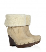 Show off your impeccable style while maintaining warmth and comfort in these wedge clogs with a cozy shearling cuff from UGG Australia - Round toe, platform, wooden wedge heel, stud-detailed trim, shearling cuff, adjustable back with D-ring buckle, ankle length - Pair with skinny jeans, an oversized cashmere sweater, and a down jacket or wool cape