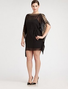 Inspired by the classic caftan, this gorgeous, sheer design features gilded trim and sultry, cold-shoulder sleeves. The self-tie belt will define your waist, creating a phenomenal silhouette. BoatneckCold-shoulder sleevesSelf-tie beltSlip includedGold embroidered trimAbout 36 from natural waistPolyesterSpot cleanImported