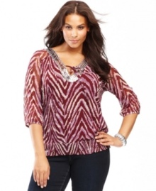 Get glowing with INC's plus size peasant top. Shimmering sequins at the neckline offset a bold print!