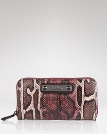 Sam Edelman's sleek snake print wallet keeps your essentials safely stowed with a secure zip around closure.