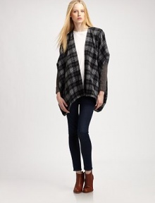 Give your cool-weather wardrobe a hit of flair with this plaid, mixed-media poncho with dropped shoulders and a lengthy silhouette. Open frontPoncho sleeves with rib-knit cuffsContoured asymmetrical hemAbout 29 from shoulder to hem50% acrylic/30% wool/20% nylonHand washImportedModel shown is 5'10 (177cm) wearing US size XS/S.