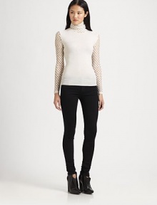 Edgy fishnet paneling emboldens this timeless merino wool sweater with ribbed trim. Fishnet turtleneckLong fishnet sleevesRibbed cuffs and hemMerino woolDry cleanMade in ItalyModel shown is 5'10 (177cm) wearing US size Small.