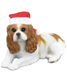 A fetching gift for animal lovers, the Cavalier King Charles Spaniel Christmas ornament depicts the adorable ruby pup waiting patiently for treats and dressed for the season. From Sandicast.