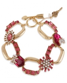 A little romance from Betsey Johnson! This toggle bracelet features fuchsia-colored crystal accents, glass pearls and key and arrow charms. Crafted in antiqued gold tone mixed metal. Approximate length: 8 inches.