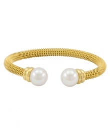 Lovely and lustrous. Organic man-made pearls adorn this beautiful bangle bracelet from Majorica. Crafted in gold tone stainless steel, it's a chic complement for your workday wardrobe. Approximate diameter: 2-1/2 inches.