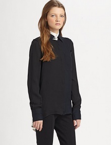 Make a fashion-forward impression with this lengthy silk blouse, defined by contrast trim and a split shirttail hem. Contrasting stand collarLong sleeves with buttoned cuffsButton frontSingle front patch pocketShirttail hem with back slitSilkDry cleanImportedModel shown is 5'7 (174cm) wearing US size 2.