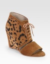 Lace-up suede confection with a unique leopard print and cutout front. Self-covered wedge, 3½ (90mm)Leopard-print suede upperLeather lining and solePadded insoleImported