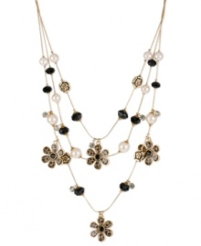 Call of the wild. Betsey Johnson's fierce illusion necklace is embellished with brown leopard flower charms, gold tone roses, black faceted and glass pearl beads and small crystal accents. Crafted in antiqued gold tone mixed metal. Approximate length: 16 inches + 3-inch extender. Approximate drop: 3-1/2 inches.