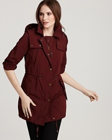 A decadent shade of plum outfits the classic Burberry Brit trench for a bold take on a sleek silhouette.