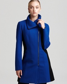 Embracing the season's color block trend, this Calvin Klein coat takes on a touch of edge with an asymmetric front zip and a funnel neck collar as seen on the runways. Add fashion-forward style to your workweek wardrobe or slip it over an LBD for cocktails.