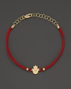 Diamonds in 14K. yellow gold from a dazzling hamsa charm, strung on red rope. By Meira T.