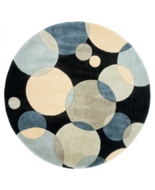 Abstract and absorbing, this rug features a multi-circle pattern in gray, taupe and an array of blues. Reminiscent of modern art paintings, it adds striking modernity and grace to your home. Hand-tufted and hand-carved of plush wool.